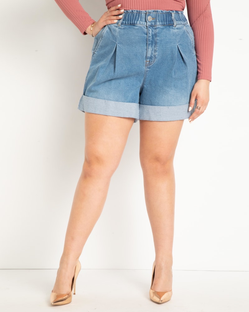 Front of a model wearing a size 14 Elastic Waistband Shorts with Pleat Detail in Medium Wash by ELOQUII. | dia_product_style_image_id:284371
